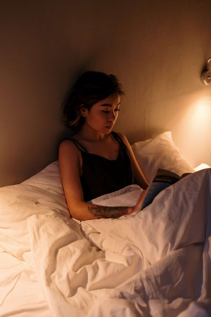 woman reading in bed